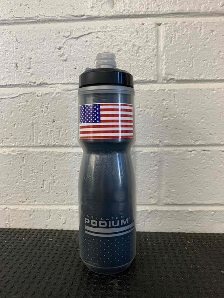 Insulated Podium water bottle with American flag sticker on textured background