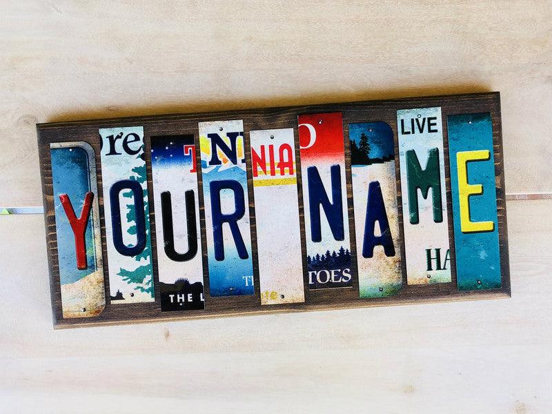 Personalized novelty sign made from vintage license plate letters spelling YOUR NAME