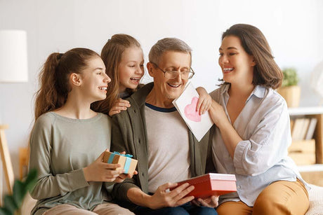 A dad with adult and teenage daughters