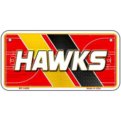 Metallic sign with 'HAWKS' text on a red, yellow, and black background
