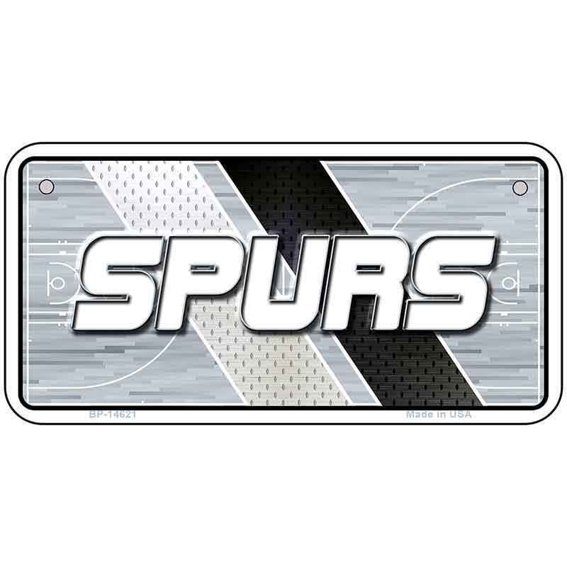 Metallic license plate with 'SPURS' text on a geometric patterned background