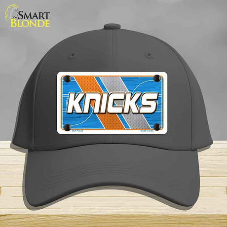 Black cap with 'Knicks' logo on a gray background