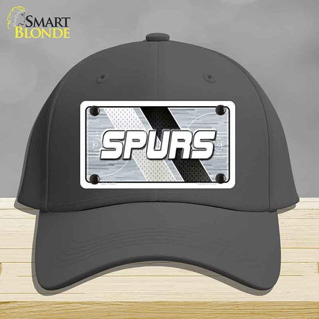 Black cap with 'SPURS' logo on a gray background