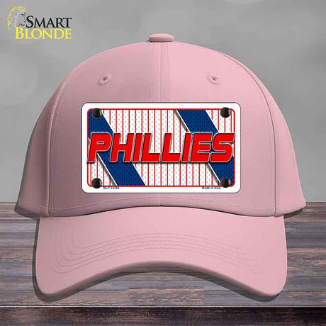 Pink cap with Phillies logo on a wooden surface