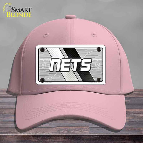Pink cap with 'NETS' logo on a gray background