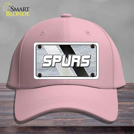 Pink cap with 'SPURS' logo on a gray background