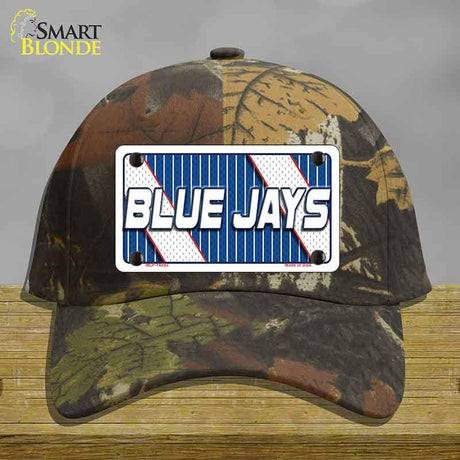 Camouflage cap with a 'Blue Jays' license plate design on a wooden surface.