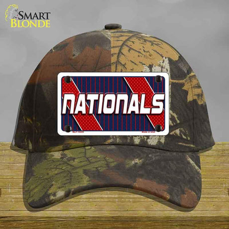 Camouflage cap with a 'Nationals' license plate design on a wooden surface.