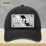Black cap with 'NETS' logo on a gray background