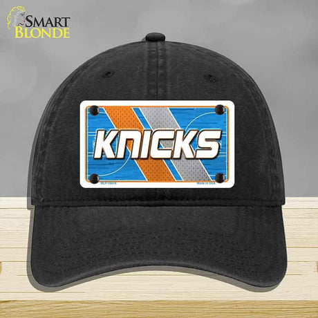 Black cap with 'Knicks' logo on a gray background