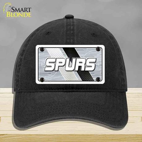 Black cap with 'SPURS' logo on a gray background