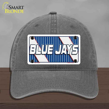 Gray cap with a 'Blue Jays' license plate design on a wooden surface