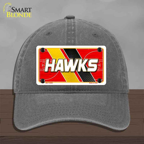 Gray cap with a red and yellow 'HAWKS' license plate design on a gray background