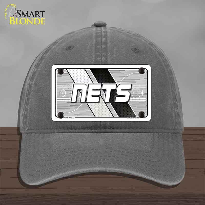 Gray cap with 'NETS' logo on a wooden surface and gray background