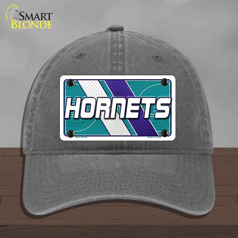 Gray cap with Hornets logo on a wooden surface