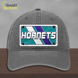 Gray cap with Hornets logo on a wooden surface