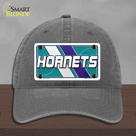 Gray cap with Hornets logo on a wooden surface