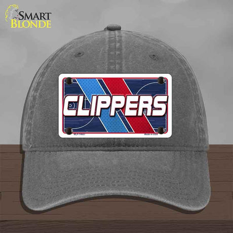 Gray cap with a 'CLIPPERS' logo on a wooden surface and gray background