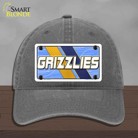 Gray cap with 'GRIZZLIES' logo on a wooden surface
