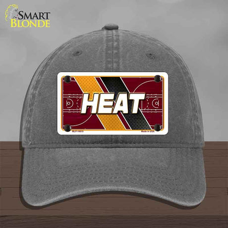 Gray cap with 'HEAT' license plate design on a wooden surface