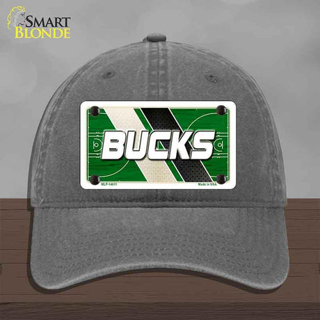 Gray cap with a 'Bucks' license plate design on a wooden surface