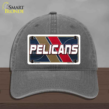 Gray cap with a 'Pelicans' license plate design on a wooden surface