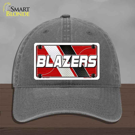 Gray cap with 'BLAZERS' license plate design on a wooden surface