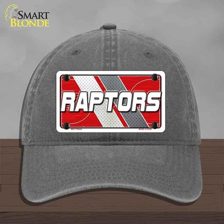 Gray cap with 'RAPTORS' logo on a wooden surface