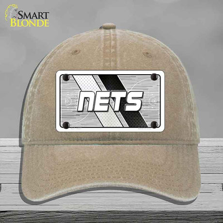 Beige cap with a 'NETS' logo on a gray background