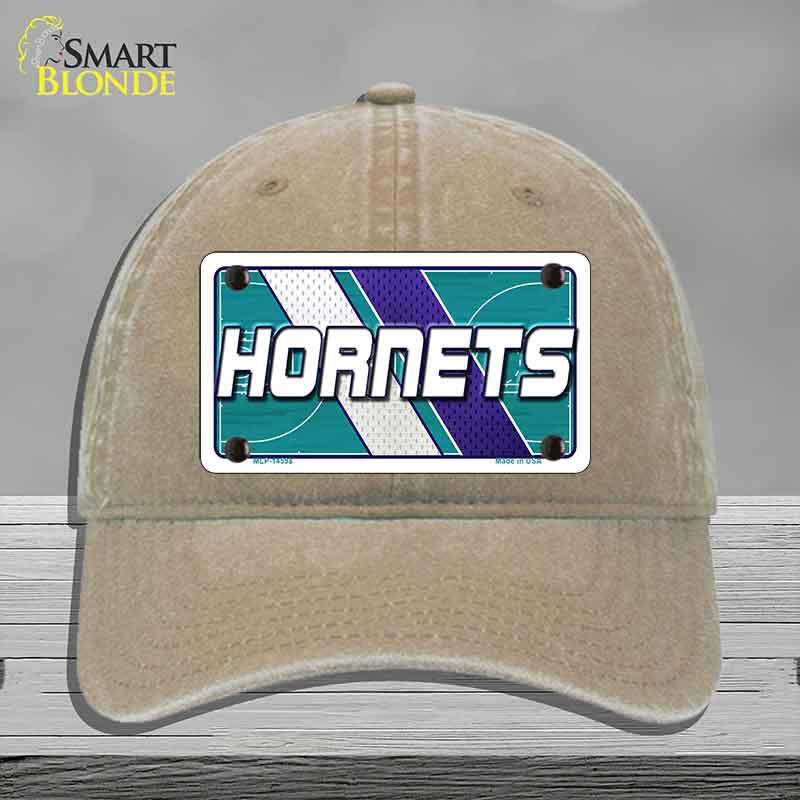 Beige cap with Hornets logo on a gray background