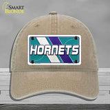 Beige cap with Hornets logo on a gray background