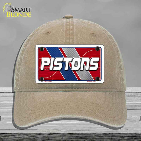Beige cap with 'PISTONS' logo on a gray background