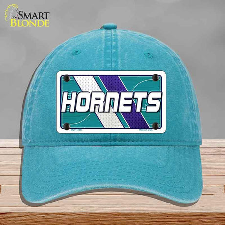 Blue cap with 'Hornets' logo on a gray background