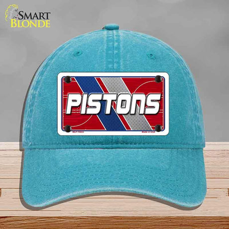 Blue cap with a 'Pistons' logo on a gray background