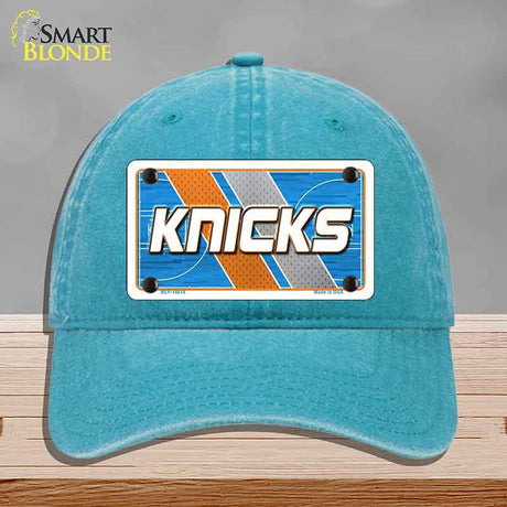 Blue cap with 'Knicks' logo on a gray background