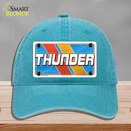 Blue cap with 'THUNDER' design on a gray background