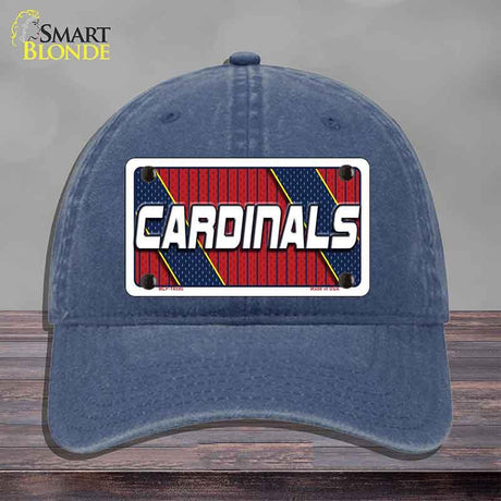 Blue cap with 'Cardinals' logo on a wooden surface