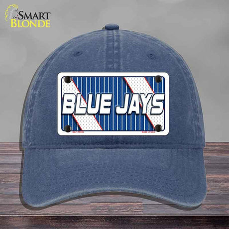 Blue cap with 'Blue Jays' logo on a wooden surface