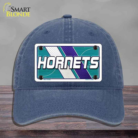 Blue cap with Hornets logo on a gray background