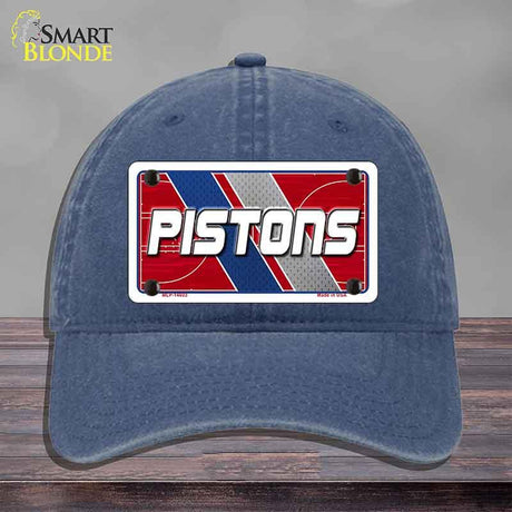 Blue cap with 'PISTONS' logo on a gray background