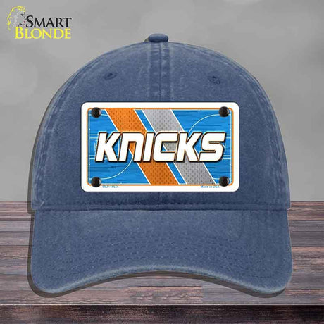 Blue cap with 'Knicks' logo on a gray background