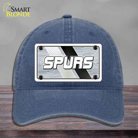 Blue cap with 'SPURS' logo on a gray background