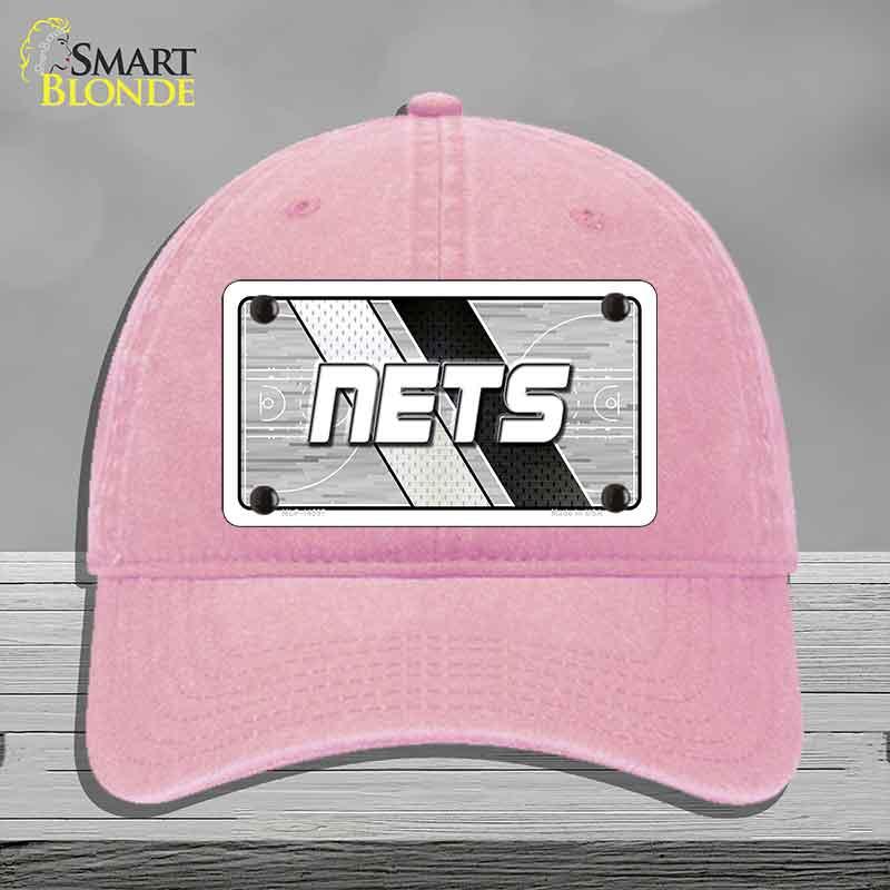 Pink cap with 'NETS' logo on a gray background