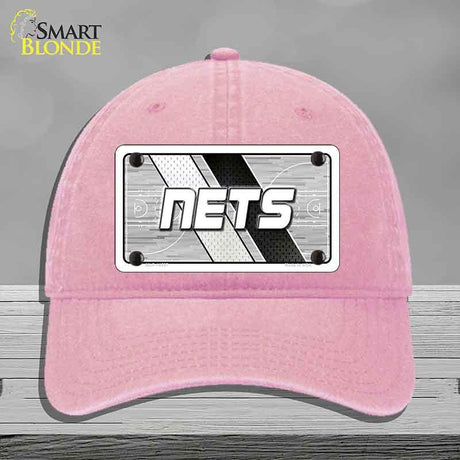 Pink cap with 'NETS' logo on a gray background
