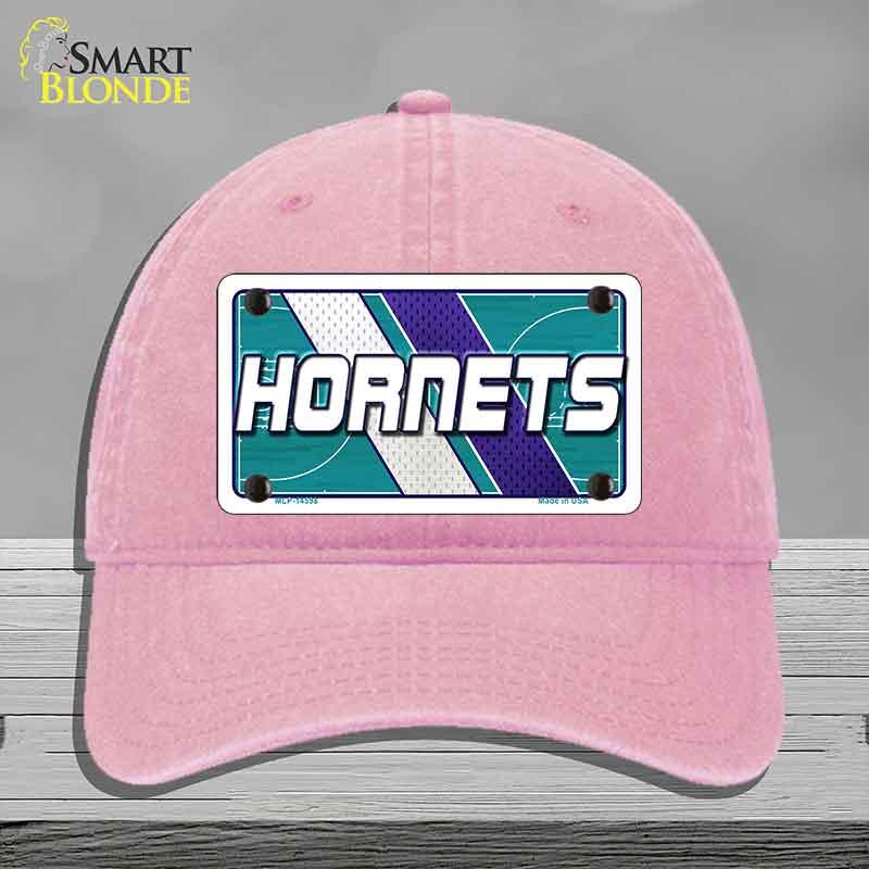Pink cap with Hornets logo on a gray background