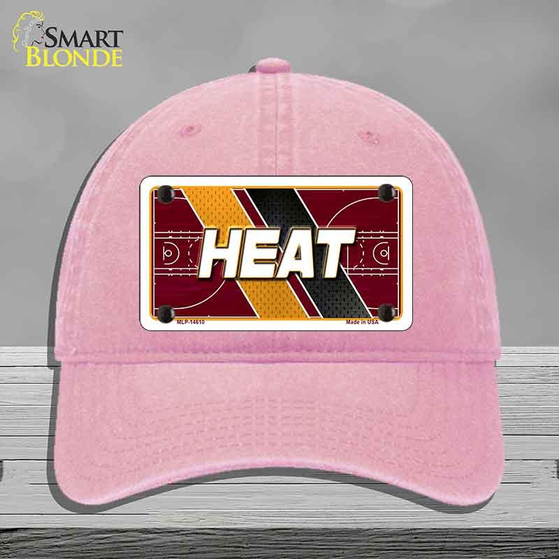 Pink cap with 'HEAT' design on a gray background