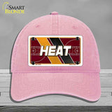 Pink cap with 'HEAT' design on a gray background