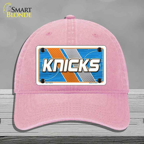 Pink cap with 'Knicks' logo on a gray background