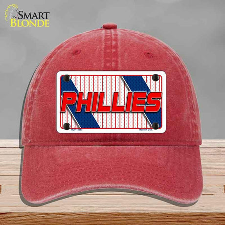 Red cap with Phillies logo on a gray background