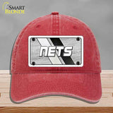 Red cap with 'NETS' logo on a gray background